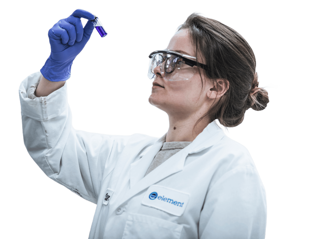 Element®168一分钟极速赛车官网预测最新结果记录 laboratory scientist wearing safety goggles and a white lab coat with the Element®全国168一分钟极速汽车开奖记录体彩®168一分钟极速赛车官网预测最新结果记录 logo, inspecting a test tube containing a purple sample during materials testing.