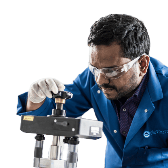 Element testing specialist examining precision measurement equipment for materials analysis